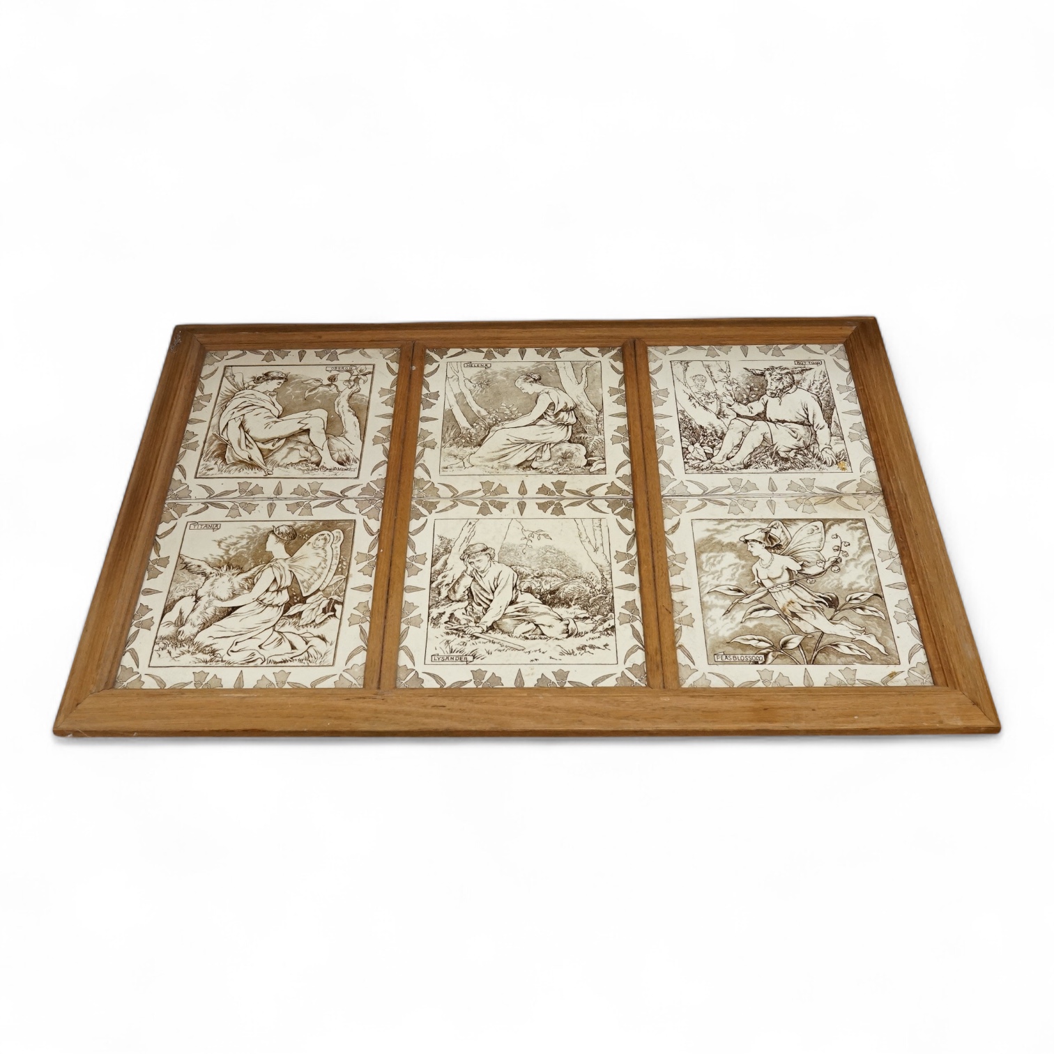 A set of six Wedgwood Midsummer Night’s Dream tiles, framed as one: Titania, Helena, Oberon, Bottom, Lysander and Peas Blossom, overall 48 x 73cm